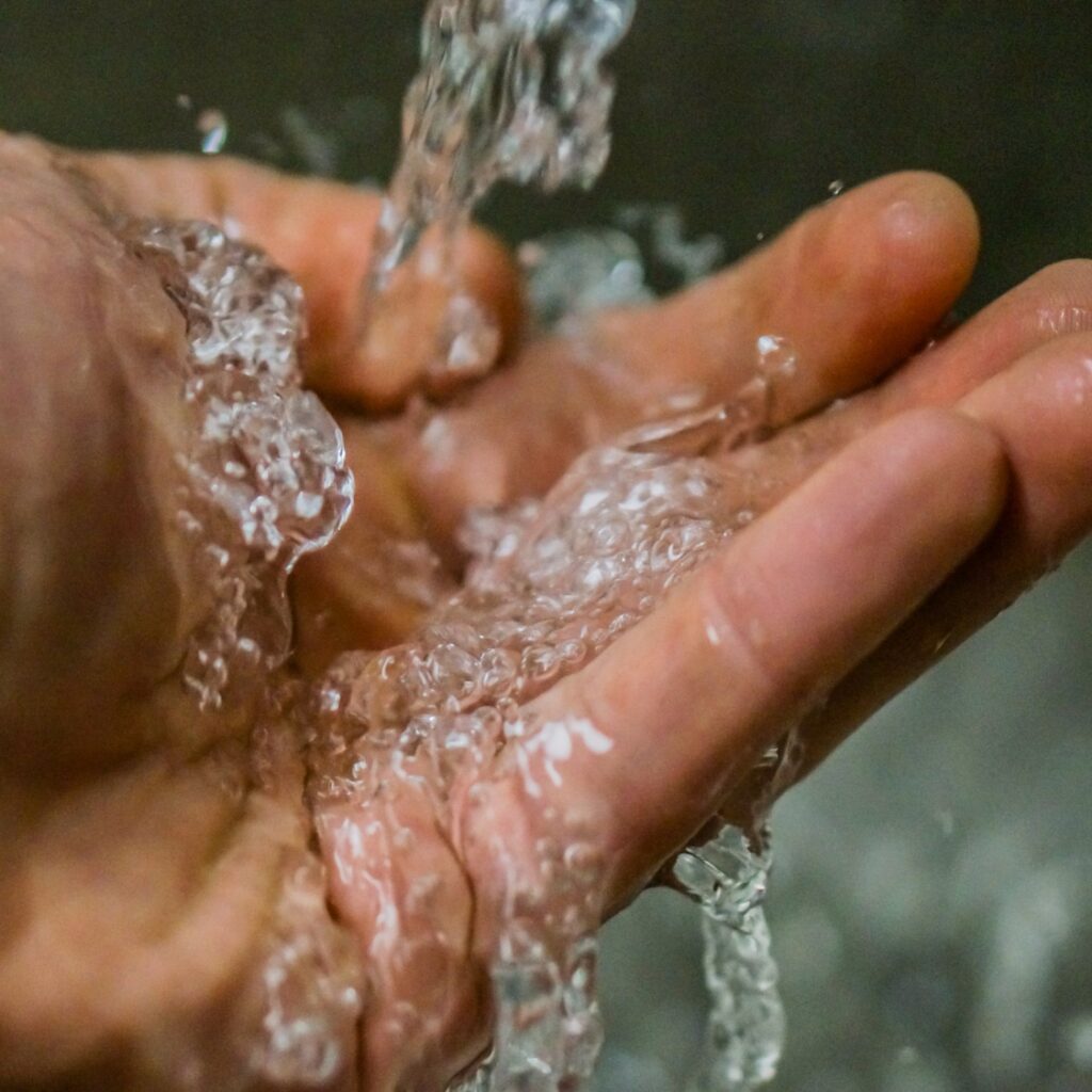 Clean water is running on the hand