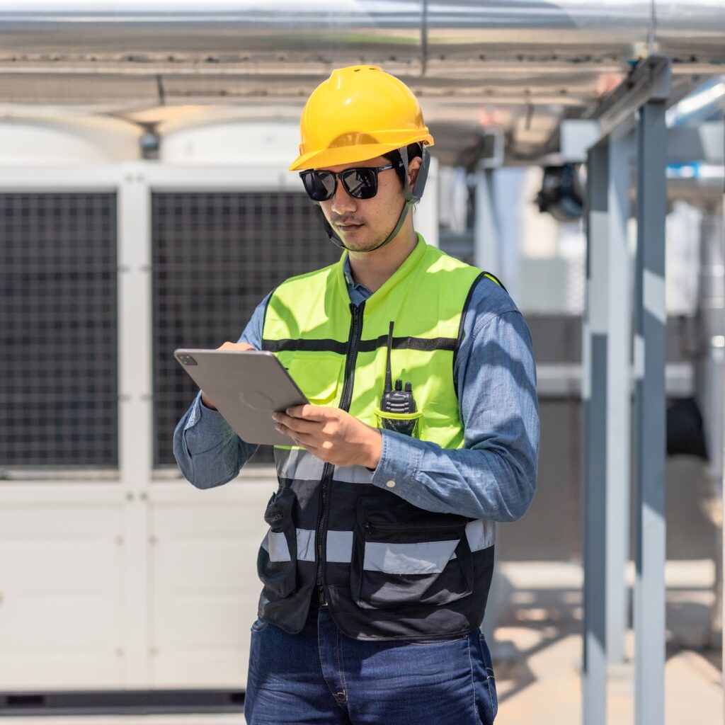 HVAC technician analyzes mechanical, electrical, plumbing systems with energy efficiency plan