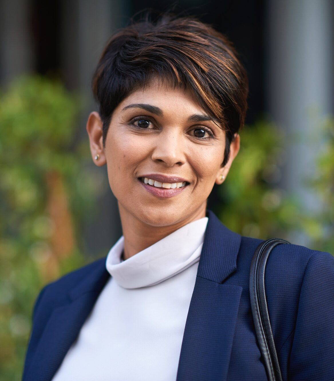 Portrait confident hispanic business woman smiling in city success testimonial